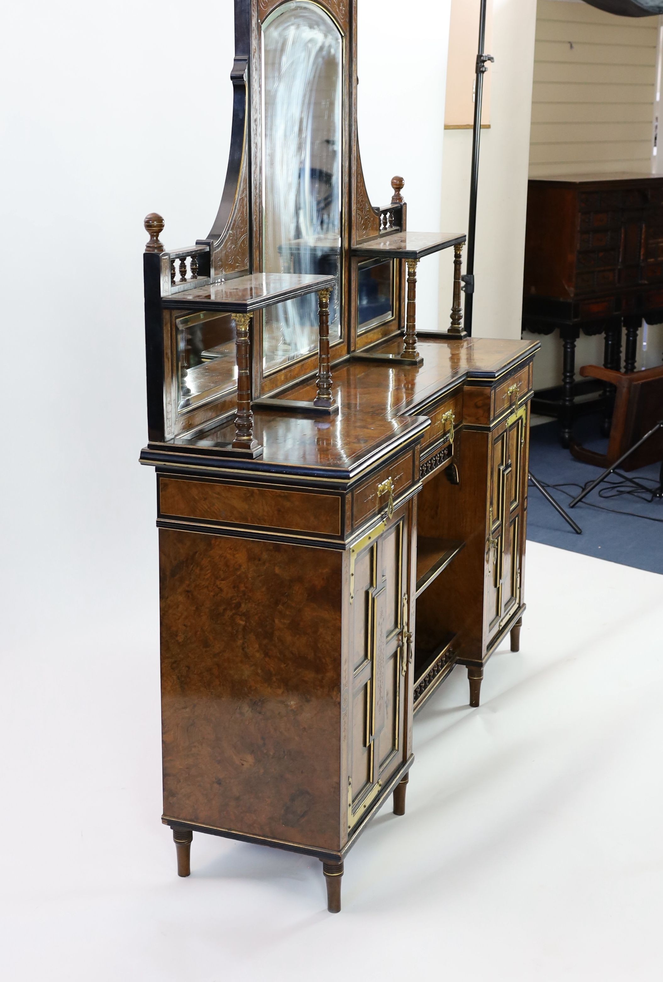 Henry William Batley (1846-1932) for Shoolbred & Co. A Victorian aesthetic movement walnut and ebonised chiffonier, W.168cm D.47cm H.204cm